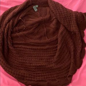 A brown/red colored sweater